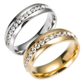 Macro detail of silver and gold stainless steel rings with walnut wood inlay and zircons