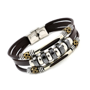 Macro detail of multilayer brown leather braided bracelet with metal anchor magnetic clasp