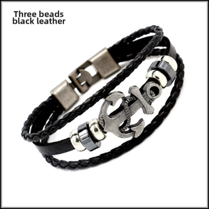 Detail of vintage anchor charm leather bracelet with three metal beads and sturdy clasp