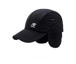 Detail showing windproof black winter sports cap with ear flaps and SPORT logo