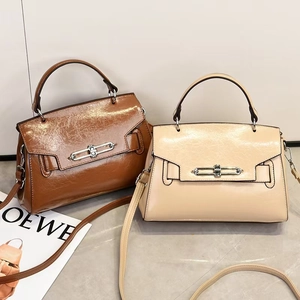Detail view of retro crossbody bags in caramel and beige colors with metal locks