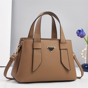 Classic brown pebble leather handbag with top handles and adjustable crossbody strap