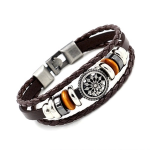 Brown leather braided bracelet featuring a metallic sun flower disc and beaded accents