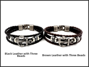 Detail view of black and brown braided leather anchor bracelets with silver beads