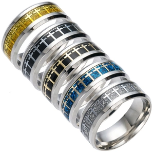 Close-up of stainless steel cross rings with glitter texture and various color finishes