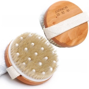 Close-up of wooden bath brush with natural bristles and white massage nodes