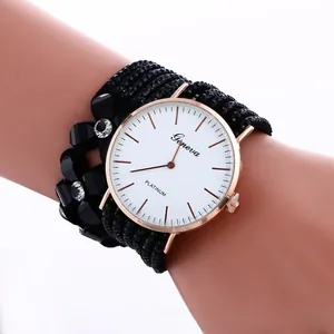 Detail of multi-strand beaded watch band with black floral accents and crystal inlay