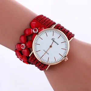 Detail view of red wrap-around watch with floral design and crystal embellishments