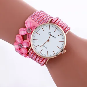 Detail view of pink multi-layer wrap watch with floral charms and sparkling rhinestones
