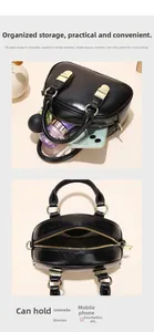 Internal structure of black leather handbag showing large capacity for umbrella and phone