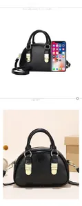Detail view of the black Boston bag size comparison with smartphone and gold hardware