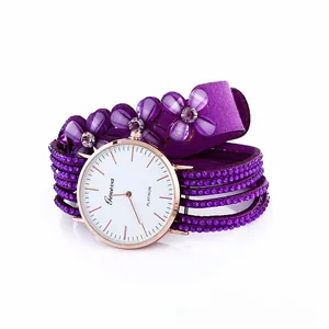 Detail of purple wrap bracelet watch with sparkling crystals and decorative floral petals