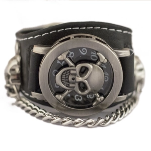 Punk style wide black leather cuff watch featuring a 3D skull dial and metal chain detail