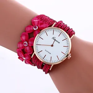 Close-up of rose red fabric flower watch strap with sparkling pink and white rhinestones