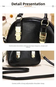 Detail view of glossy black faux leather crossbody bag with gold metal buckle and strap