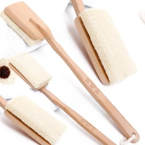 Detail of wooden bath brush with natural loofah head and hanging rope on handle