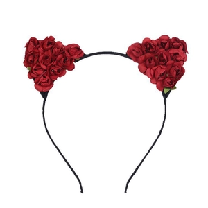 Detailed view of red faux roses forming cat-ear shapes on a slim black festive headband