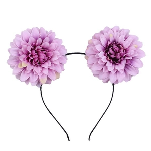 Detailed close-up of purple faux dahlia flowers on a black headband for costume parties