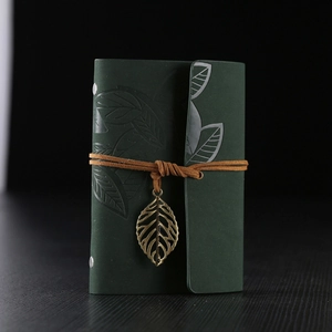 Vintage dark green leather notebook with leaf embossed cover and bronze pendant strap
