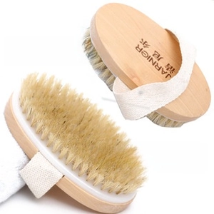 Close-up of dual-sided wooden body brush with natural bristles and a woven cotton strap