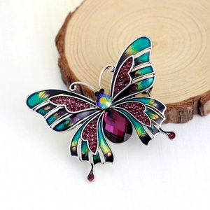 Vintage butterfly brooch with colorful enamel wings and sparkling red rhinestones
