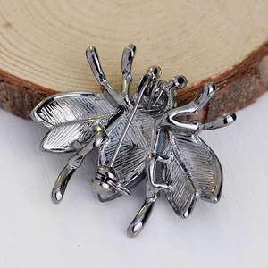 Deep silver bee brooch with rhinestones showing metal back and pin closure