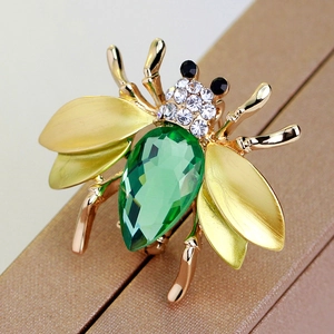 Exquisite gold honey bee brooch with green gemstone and white crystal accents