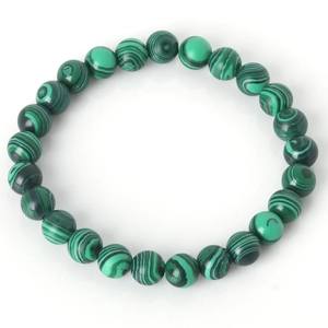Macro detail of natural malachite beaded bracelet showing green wavy patterns and texture