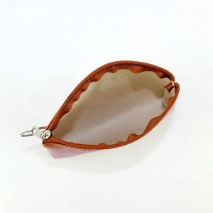 Detailed interior view of a vintage Eiffel Tower coin purse with zipper and key ring