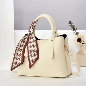 Cream lychee textured handbag with houndstooth silk scarf handle and crossbody strap