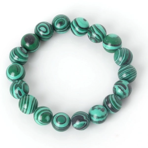 Macro detail of malachite bead bracelet showing green circular patterns and textures