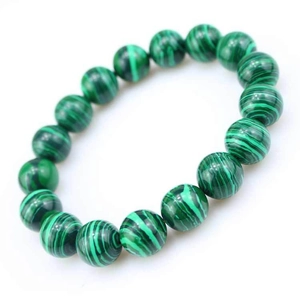 Macro view of green malachite beaded bracelet showing natural stone textures and patterns