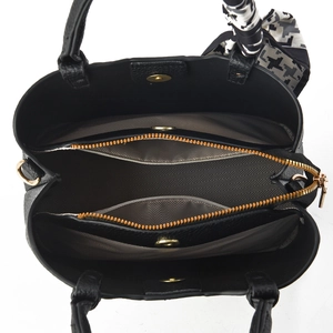 Detail of black pebbled leather tote interior with herringbone lining and silk scarf
