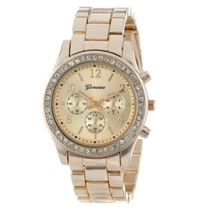 Close-up of golden metal watch dial with rhinestones and decorative sub-dials