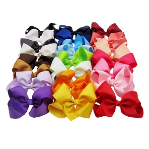 Collection of large 15cm children's hair bows in multiple vibrant colors on white background