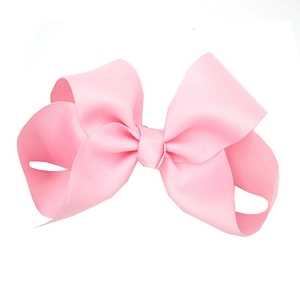 Detail shot of a large pink grosgrain ribbon bow hairpin for baby girls hair accessory