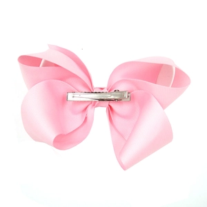 Detail of a large 15cm pink ribbon hair bow clip for babies with high-quality fabric texture