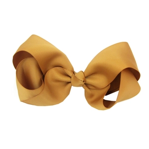 Detail of 15cm mustard yellow grosgrain ribbon hair bow for babies on white background