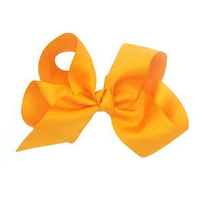 Detailed view of 15cm large orange ribbed grosgrain ribbon hair bow for babies