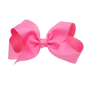 Detail of pink 15cm grosgrain ribbon hair bow for kids with textured fabric and soft knot