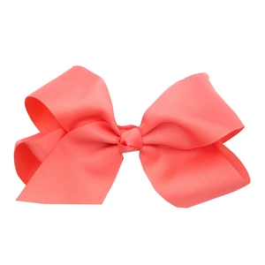 Detail of a 15cm coral pink grosgrain ribbon hair bow for babies on white background