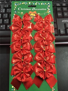 Set of 12 red glitter Christmas bows on green card packaging for festive decorations
