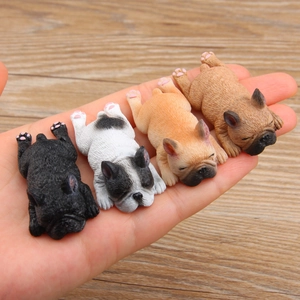 Set of four mini French Bulldog resin figurines in various colors held in a hand