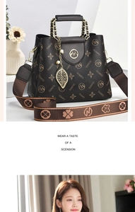 Detailed macro view of OUMIFEI crossbody bag featuring monogram pattern and gold leaf pendant