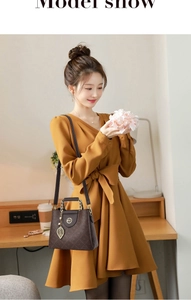 Detailed model shot of a brown monogram crossbody bag with golden leaf pendant