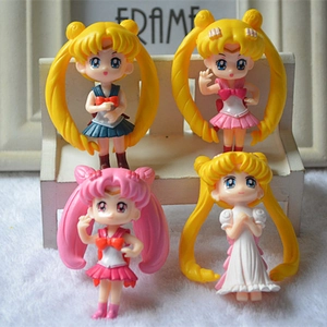 Detail view of 4-piece Sailor Moon mini figure set on a white decorative bench