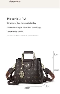 Detailed view of dark brown PU leather handbag with floral strap and pearl leaf charm