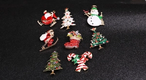 Detail view of 8-piece enamel Christmas brooch set with colorful rhinestones on black base