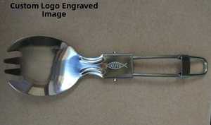 Detail of folding stainless steel spork with engraved fish totem on brown background