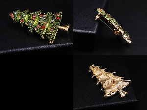 Detailed views of a gold Christmas tree brooch with green enamel and colorful crystals